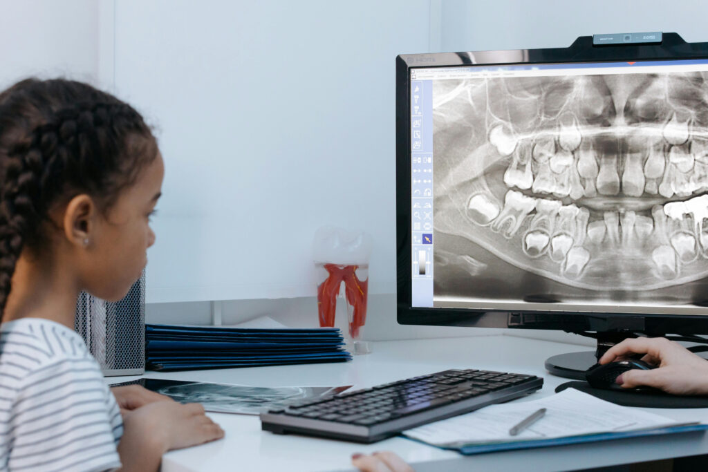 Young girl at the dentist looking at x-rays